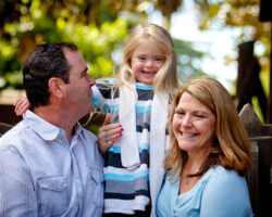 Dad, mom and blond daughter at the park