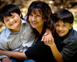 Mom and two sons in the park, all hugging