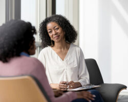 Service coordinator sits with person served, listening with care