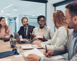 Group of stakeholders have a discussion at a conference table