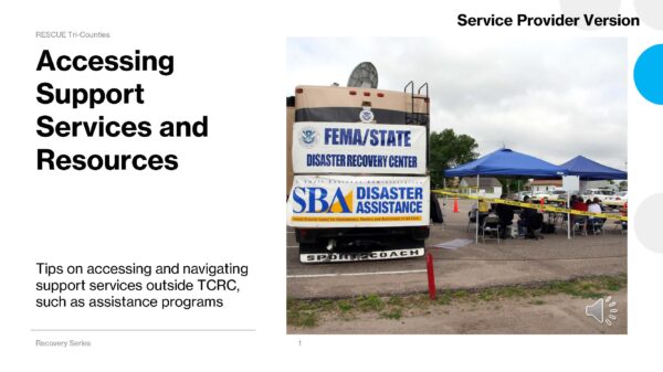 Accessing Support Services and Resources “FEMA/State disaster recovery center trailer and SBA Disaster Assistance banner beside a blue canopy and tables behind yellow caution tape.”