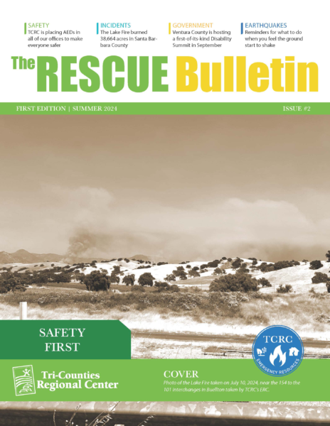 Sepia‐toned cover titled ‘The RESCUE Bulletin First Edition | Summer 2024’ showing a wide California hills landscape with smoke from the Lake Fire in the distance. A green banner at bottom reads ‘Safety First’ over the Tri-Counties Regional Center logo and the TCRC Emergency Resources emblem.